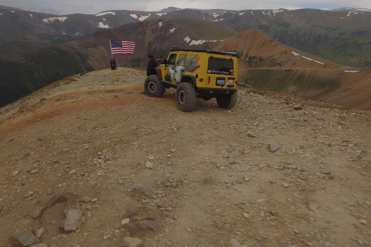 Yellow TNT Customs Jeep at the top of the Red Cone trail