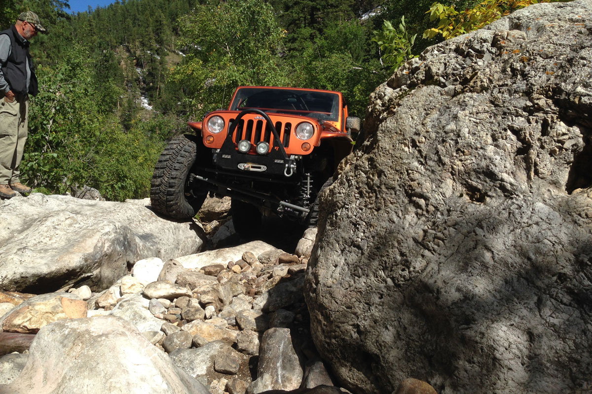 Orange Jeep rock climbing