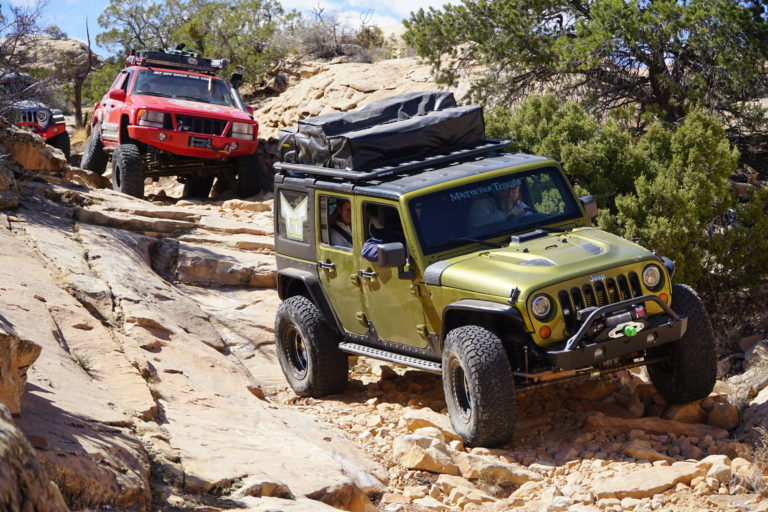 Green jeep leading the overland group on the trail