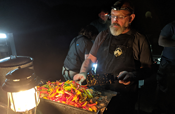 Bob Levenhagen cooking camp dinner in the dark
