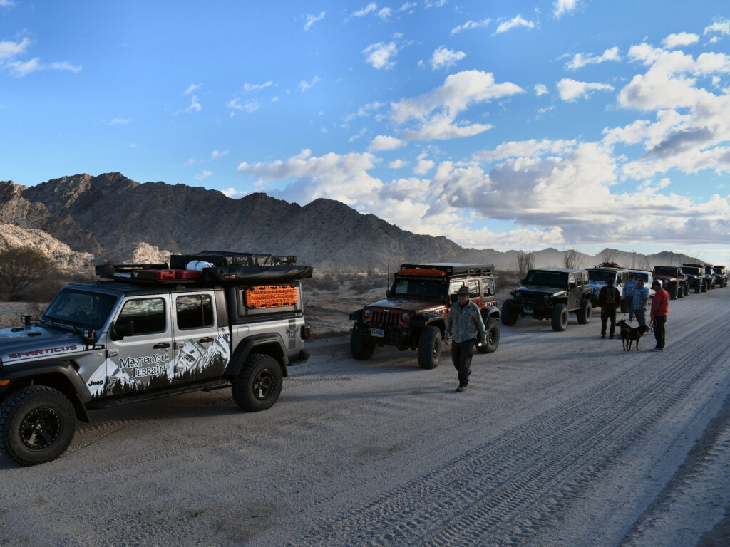 The vehicles pulled over before hiking into the canyon to visit Tule Well.